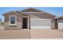 Cozy home featuring a low maintenance front yard, attached two car garage, and covered entryway at 18268 W La Senda Dr, Surprise, AZ 85387