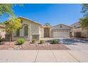 Inviting single-story home featuring a beautifully landscaped front yard and a two-car garage at 2024 W Darrel Rd, Phoenix, AZ 85041
