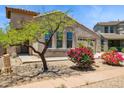 Inviting home with lush landscaping, mature trees, and a convenient two-car garage in a suburban neighborhood at 35314 N 31St Ave, Phoenix, AZ 85086
