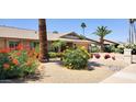 A well-kept, single-story home featuring low maintenance landscaping and a two-car garage at 4617 E Emile Zola Ave, Phoenix, AZ 85032