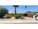 Single-story home showcasing desert landscaping, a two-car garage, and a well-maintained lawn at 4617 E Emile Zola Ave, Phoenix, AZ 85032