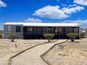 Charming single-story home with covered porch and desert landscaping at 50525 W Whirly Bird Rd, Maricopa, AZ 85139