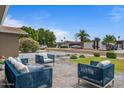 Inviting patio area with stylish wicker furniture and meticulously maintained landscaping and lawn at 5332 N 81St Pl, Scottsdale, AZ 85250