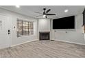 Bright living room featuring a fireplace, stylish flooring, and a modern ceiling fan at 5704 E Aire Libre Ave # 1093, Scottsdale, AZ 85254