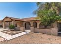 Single-story home featuring a covered entrance, low front walls, and desert landscaping at 7340 W Meadowbrook Ave, Phoenix, AZ 85033