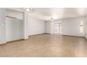 Bright, empty living room featuring tile floors, neutral walls, and sliding glass door to the backyard at 7340 W Meadowbrook Ave, Phoenix, AZ 85033