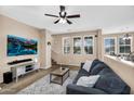 Living room boasts ample natural light, a ceiling fan, and a clear view of the staircase at 7718 W Pipestone Pl, Phoenix, AZ 85035