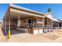Inviting single-story home with a spacious carport and well-maintained yard and mature palm trees at 7750 E Broadway Rd # 357, Mesa, AZ 85208