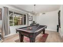 A game room features a billiards table, decorative lighting, and a view to the exterior at 837 W Keating Ave, Mesa, AZ 85210
