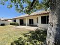 Lush backyard featuring a well-kept lawn and a covered patio, ideal for outdoor living and entertaining at 8759 W Port Au Prince Ln, Peoria, AZ 85381
