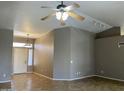 Inviting living room with tiled floors, ceiling fan, and neutral paint, offering a bright and spacious feel at 8759 W Port Au Prince Ln, Peoria, AZ 85381
