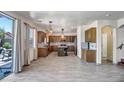 Gourmet kitchen with a large island, stainless steel appliances, granite counters, and wood-look tile flooring at 11936 W Alvarado Rd, Avondale, AZ 85392