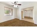 A bedroom with a view into the living room, featuring carpet and tile flooring at 12089 N 145Th Dr, Surprise, AZ 85379