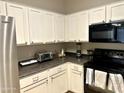 Bright kitchen featuring white cabinets and modern appliances at 1350 S Greenfield Rd # 2231, Mesa, AZ 85206