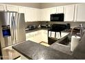 Well-equipped kitchen with stainless steel fridge and dark countertops at 1350 S Greenfield Rd # 2231, Mesa, AZ 85206