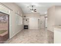 Spacious living room featuring a fireplace, tile flooring, and bright natural light with access to the backyard at 14314 W Lexington Ave, Goodyear, AZ 85395