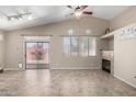 Bright living room showcasing a fireplace, tile floors, with access to the back yard at 14314 W Lexington Ave, Goodyear, AZ 85395