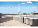A cozy outdoor patio with views of the surrounding neighborhood street, a perfect space for relaxation at 18153 W Hiddenview Dr, Goodyear, AZ 85338
