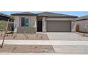 Charming single-story home featuring a two-car garage and low maintenance desert landscaping at 18248 W La Senda Dr, Surprise, AZ 85387
