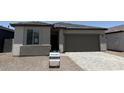 Charming single story home with a two car garage and neutral colored stucco finish at 18248 W La Senda Dr, Surprise, AZ 85387