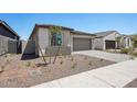 Charming single-story home featuring a two-car garage and low maintenance desert landscaping at 18248 W La Senda Dr, Surprise, AZ 85387
