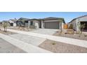 Charming single-story home featuring a two-car garage and low maintenance desert landscaping at 18248 W La Senda Dr, Surprise, AZ 85387