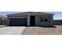 Beautiful single-story home featuring a gray exterior, a two-car garage, and desert landscaping at 18269 W Camino De Oro --, Surprise, AZ 85387