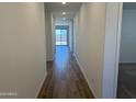 Inviting hallway boasts stylish wood-look tile flooring and recessed lighting leading to a bright living space at 18269 W Camino De Oro --, Surprise, AZ 85387