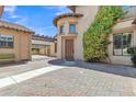 Beautiful courtyard with custom brickwork, mature landscaping, and a charming architectural design at 2652 N 143Rd Dr, Goodyear, AZ 85395