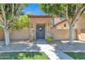 Unique entrance with elephant statues, stone pathway, and decorative wreath on front door at 2652 N 143Rd Dr, Goodyear, AZ 85395