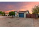 Cozy home with a blue garage door and brick detailing, nestled in a quiet neighborhood at 332 S 83Rd Pl, Mesa, AZ 85208