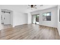Spacious living room with sliding glass door, wood floors, and barn door at 3898 E Palmer St, Gilbert, AZ 85298