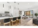 Open-concept layout with island seating, modern lighting, and view to a stylish living area at 4220 N 32Nd St # 14, Phoenix, AZ 85018