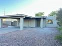 Home exterior features a carport, xeriscaping, and neutral color palette at 4902 S Fair Ln, Tempe, AZ 85282