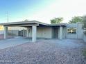 Home exterior features a carport, xeriscaping, and neutral color palette at 4902 S Fair Ln, Tempe, AZ 85282