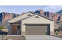 Charming single-story home featuring desert landscaping, a neutral color scheme, and a two-car garage at 5019 E Umber Rd, San Tan Valley, AZ 85143