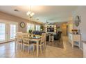 Bright dining area adjacent to the living room, featuring a dining table and views of the backyard at 5737 W Hidalgo Ave, Laveen, AZ 85339