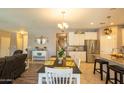 Open-concept kitchen with stainless steel appliances, granite countertops, and a breakfast bar for casual dining at 5737 W Hidalgo Ave, Laveen, AZ 85339