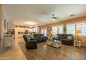 Spacious living room featuring hardwood floors and comfortable seating arrangements, with an open view to the kitchen at 5737 W Hidalgo Ave, Laveen, AZ 85339