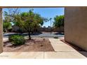 View of a quiet residential street with mature trees, creating a peaceful atmosphere at 64 N 63Rd St # 25, Mesa, AZ 85205