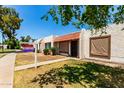 Charming home exterior with decorative tile roof and cozy front patio with a sign post on the left at 6606 N 46Th Ave, Glendale, AZ 85301