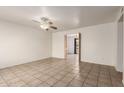Spacious living room boasts tile flooring and a ceiling fan, offering a blend of comfort and style at 6606 N 46Th Ave, Glendale, AZ 85301