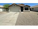 Single-story home featuring a well-maintained front yard, a driveway, and an attached garage at 740 W Dublin St, Gilbert, AZ 85233
