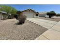 Single-story house with a low-maintenance desert front yard, and an attached garage at 740 W Dublin St, Gilbert, AZ 85233