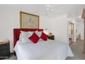 Bright main bedroom offers ample space with a striking red headboard and large picture window at 8651 E Royal Palm Rd # 121, Scottsdale, AZ 85258