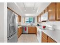 Efficient kitchen features stainless steel refrigerator and appliances with bright overhead lighting at 8651 E Royal Palm Rd # 121, Scottsdale, AZ 85258