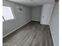 Cozy bedroom with new laminate flooring, air conditioning, and a window for natural light at 918 S Evangeline Ave, Mesa, AZ 85208