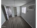 Comfortable bedroom featuring laminate flooring, neutral walls, and a closet at 918 S Evangeline Ave, Mesa, AZ 85208