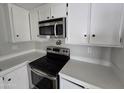Modern kitchen featuring stainless steel appliances, white cabinetry, and spacious countertops at 918 S Evangeline Ave, Mesa, AZ 85208