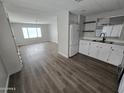 Bright living room showcasing new laminate flooring and large windows for ample natural light at 918 S Evangeline Ave, Mesa, AZ 85208